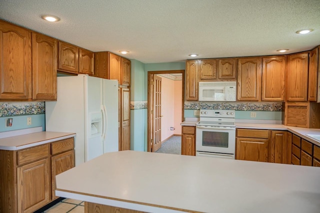 706 Tremont St, Mauston, WI 53948 - kitchen with white appliances, brown cabinets, light countertops, a textured ceiling, and recessed lighting