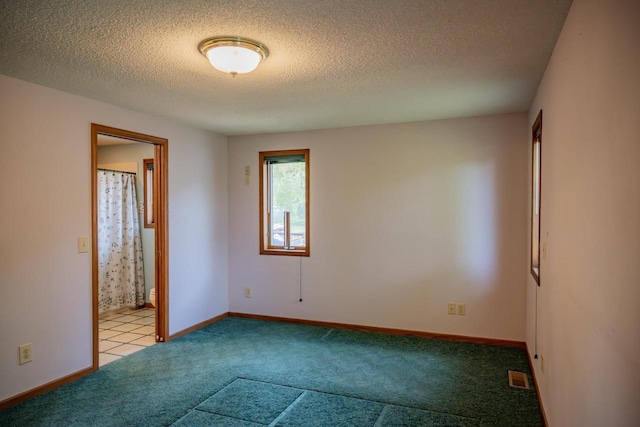 706 Tremont St, Mauston, WI 53948 - carpeted empty room featuring a textured ceiling and baseboards