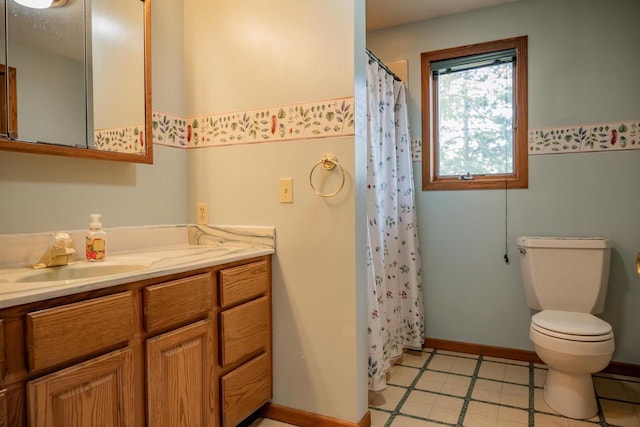 706 Tremont St, Mauston, WI 53948 - bathroom featuring vanity, toilet, a shower with shower curtain, and baseboards