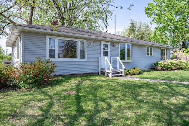 706 Tremont St, Mauston, WI 53948 - view of front of home featuring a chimney and a front yard