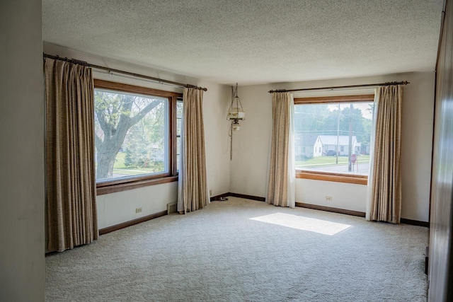 706 Tremont St, Mauston, WI 53948 - spare room with carpet flooring, a textured ceiling, and baseboards