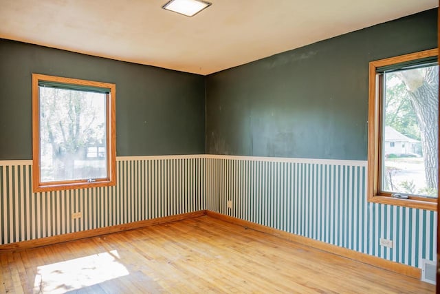 706 Tremont St, Mauston, WI 53948 - unfurnished room with hardwood / wood-style flooring and a wainscoted wall