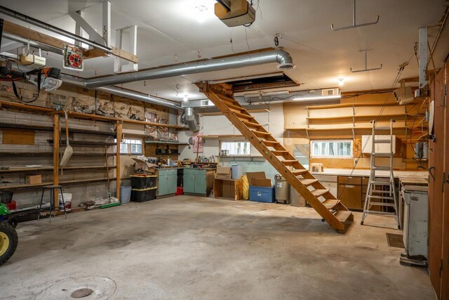 706 Tremont St, Mauston, WI 53948 - garage featuring a workshop area and a garage door opener