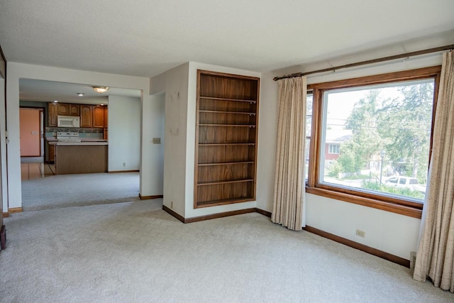 706 Tremont St, Mauston, WI 53948 - spare room featuring light carpet and baseboards