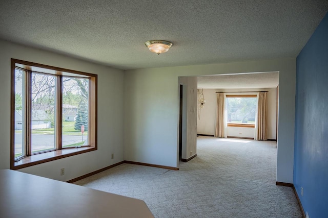 706 Tremont St, Mauston, WI 53948 - carpeted empty room featuring baseboards and a textured ceiling