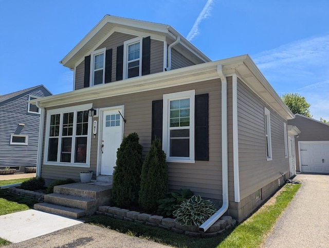 707 E Roland St, Oconomowoc, WI 53066 - view of front of house with a garage and an outdoor structure