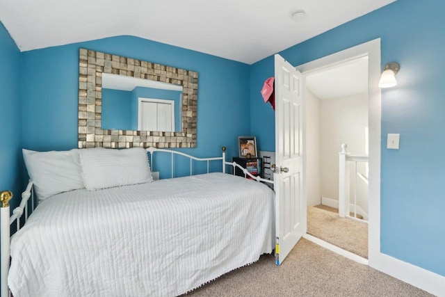 707 E Roland St, Oconomowoc, WI 53066 - bedroom featuring carpet, vaulted ceiling, and baseboards