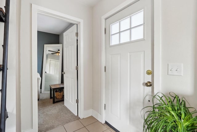 707 E Roland St, Oconomowoc, WI 53066 - entryway featuring light tile patterned floors, a ceiling fan, baseboards, and light carpet