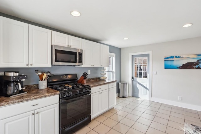 707 E Roland St, Oconomowoc, WI 53066 - kitchen featuring stainless steel microwave, black range with gas stovetop, white cabinets, recessed lighting, and light tile patterned floors