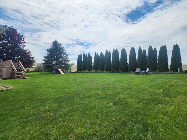 326 N 15th St, Oostburg, WI 53070 - view of green lawn with a playground, stairway, and a wooden deck