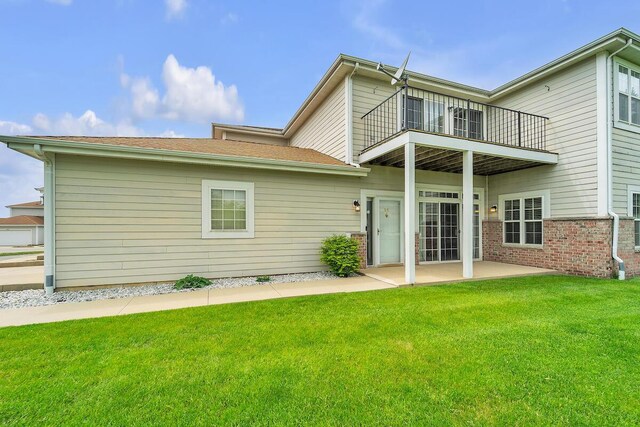 10245 66th Ave Unit 2Bb, Pleasant Prairie, WI 53158 - back of property with a balcony, a patio, a yard, and brick siding