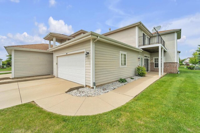 10245 66th Ave Unit 2Bb, Pleasant Prairie, WI 53158 - view of property exterior featuring a balcony, an attached garage, a lawn, and driveway