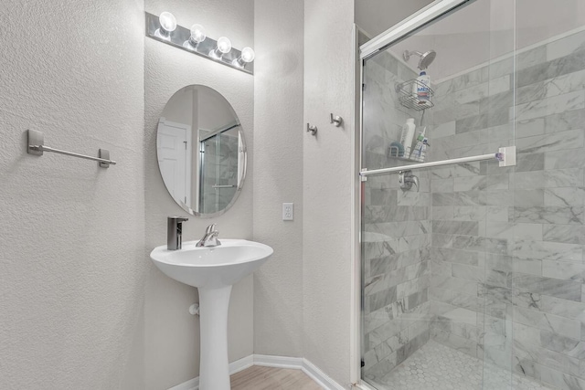 10245 66th Ave Unit 2Bb, Pleasant Prairie, WI 53158 - bathroom with a stall shower, a textured wall, and a sink