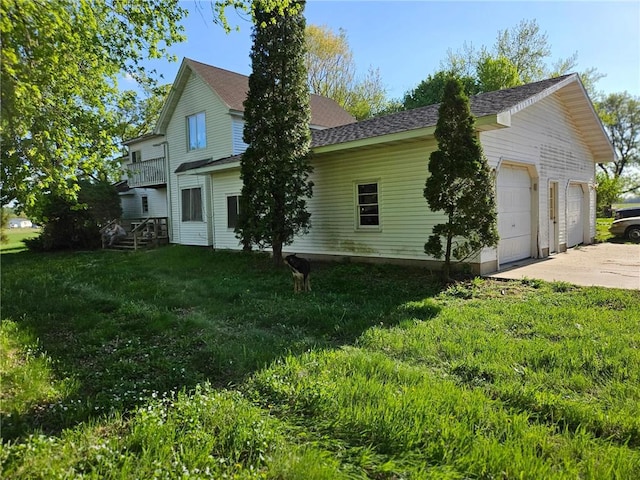 N10449 State Road 25, Wheeler, WI 54772 - view of home's exterior featuring a yard, roof with shingles, and a garage