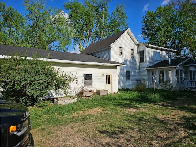 N10449 State Road 25, Wheeler, WI 54772 - rear view of house with a lawn