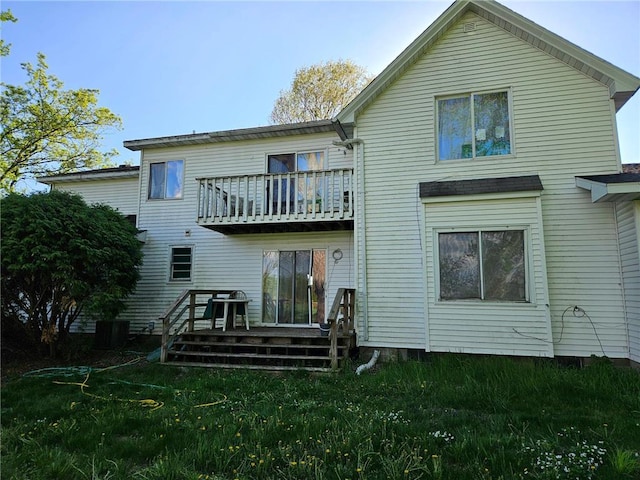 N10449 State Road 25, Wheeler, WI 54772 - rear view of house featuring a balcony, a lawn, and a deck