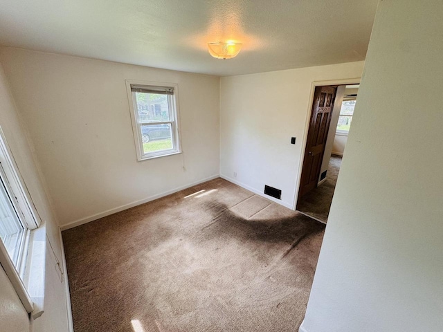 1344 Mckinley Ave, Beloit, WI 53511 - empty room with healthy amount of natural light, carpet flooring, and baseboards