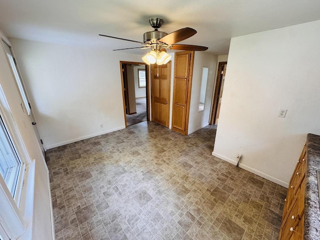1344 Mckinley Ave, Beloit, WI 53511 - empty room with baseboards, a ceiling fan, and brick patterned flooring