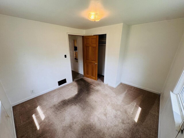 1344 Mckinley Ave, Beloit, WI 53511 - unfurnished bedroom with carpet, a closet, and baseboards