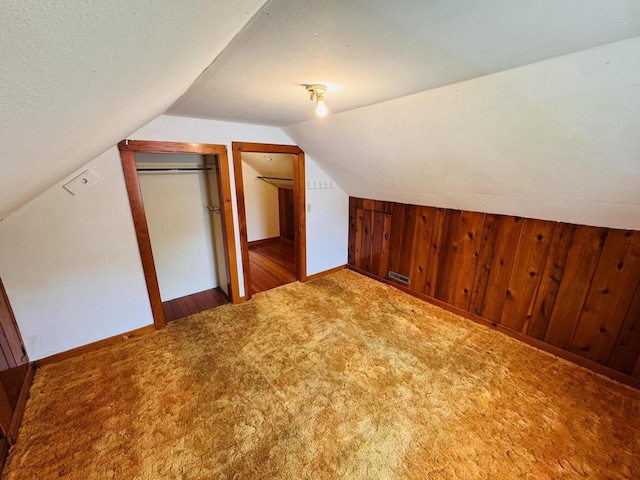 1344 Mckinley Ave, Beloit, WI 53511 - bonus room featuring carpet floors, lofted ceiling, wood walls, and baseboards