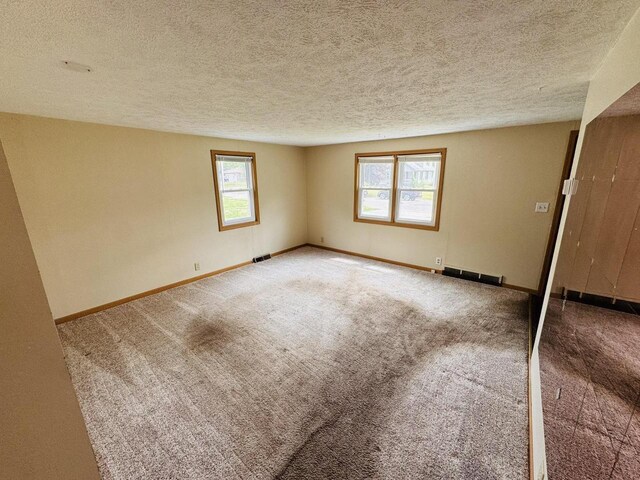 1344 Mckinley Ave, Beloit, WI 53511 - carpeted spare room with a textured ceiling and baseboards