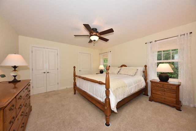 504 Sand Dr, West Bend, WI 53095 - bedroom with light carpet, a ceiling fan, baseboards, and a closet