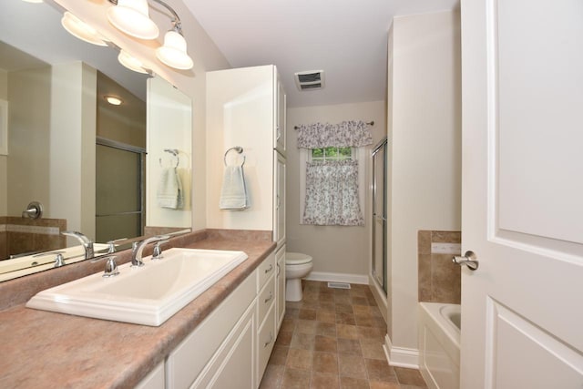 504 Sand Dr, West Bend, WI 53095 - bathroom with toilet, vanity, baseboards, a garden tub, and a shower with shower door