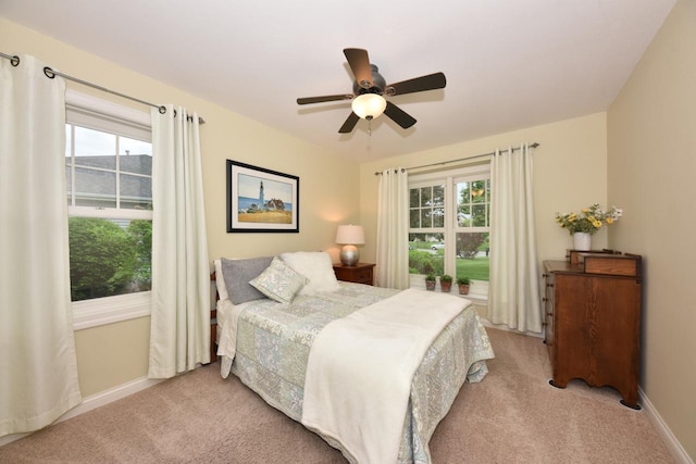 504 Sand Dr, West Bend, WI 53095 - bedroom with light colored carpet, multiple windows, and baseboards