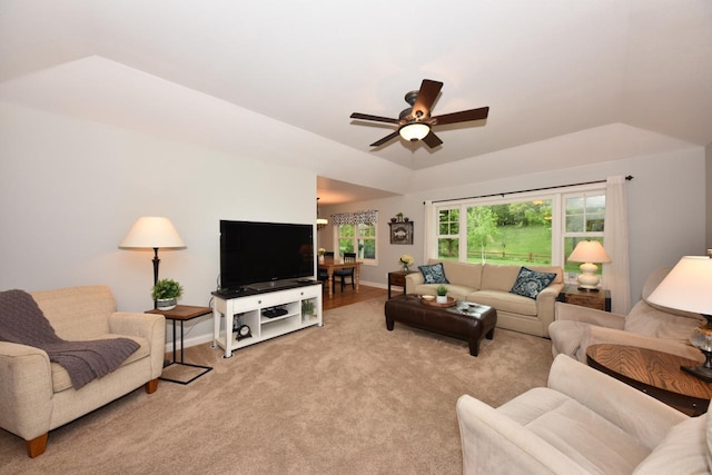 504 Sand Dr, West Bend, WI 53095 - living room featuring a ceiling fan, light carpet, baseboards, and vaulted ceiling