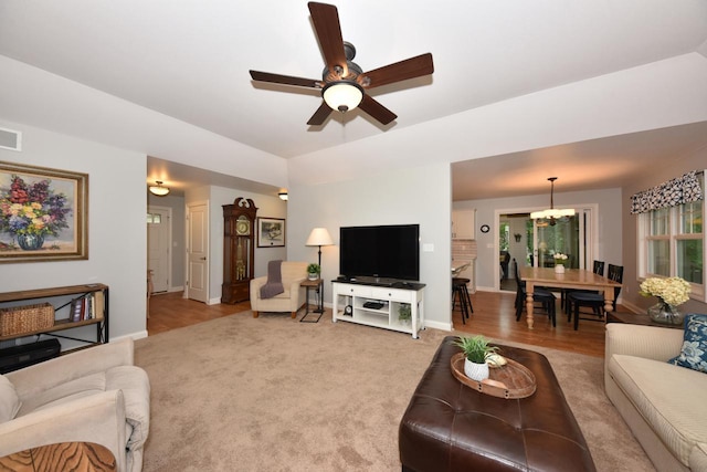 504 Sand Dr, West Bend, WI 53095 - living area with a chandelier, ceiling fan, baseboards, and light wood-type flooring