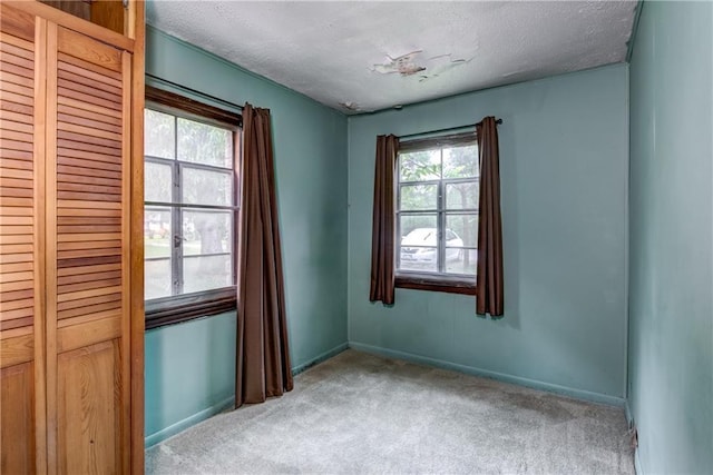 2561 86th St, Eau Claire, WI 54703 - spare room featuring light colored carpet, a textured ceiling, and baseboards