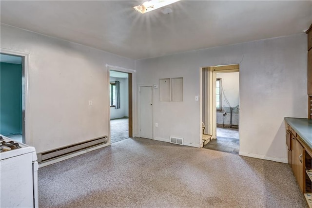 2561 86th St, Eau Claire, WI 54703 - carpeted empty room with a baseboard heating unit and baseboards