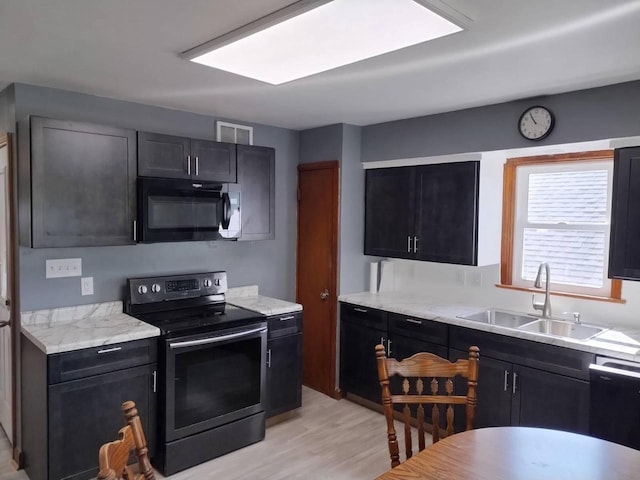 4507 S Griffin Ave, Milwaukee, WI 53207 - kitchen featuring black microwave, electric stove, a sink, dishwashing machine, and light wood-style flooring