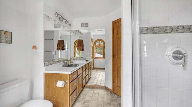 5515 Evergreen Dr, Sheboygan, WI 53081 - bathroom with vanity, toilet, a shower, tile patterned flooring, and baseboards