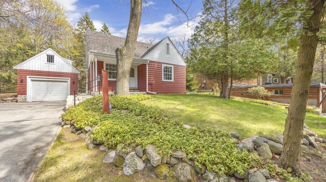 5515 Evergreen Dr, Sheboygan, WI 53081 - view of front facade with an outbuilding, a detached garage, a front lawn, driveway, and a porch