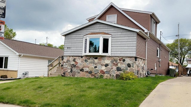 901 S 90th St, West Allis, WI 53214 - view of property exterior with a lawn and stone siding