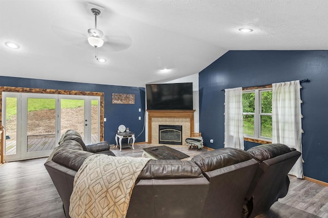 2150 E Carly Ct, Milton, WI 53563 - living area with wood finished floors, lofted ceiling, healthy amount of natural light, a ceiling fan, and baseboards