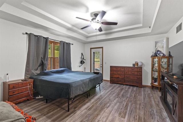 2150 E Carly Ct, Milton, WI 53563 - bedroom featuring a raised ceiling, access to outside, wood finished floors, a ceiling fan, and baseboards