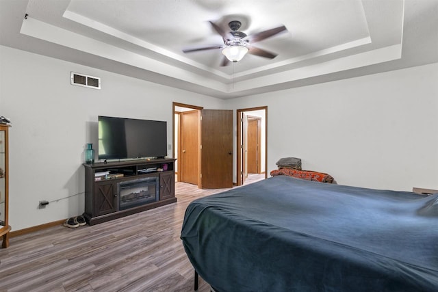 2150 E Carly Ct, Milton, WI 53563 - bedroom with a tray ceiling, wood finished floors, baseboards, and a ceiling fan