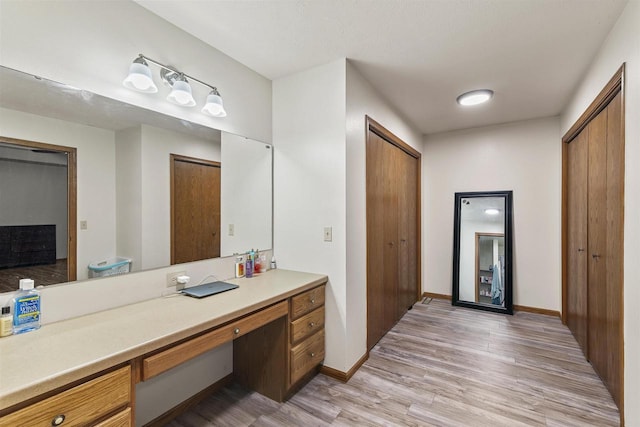 2150 E Carly Ct, Milton, WI 53563 - bathroom featuring wood finished floors, vanity, and baseboards