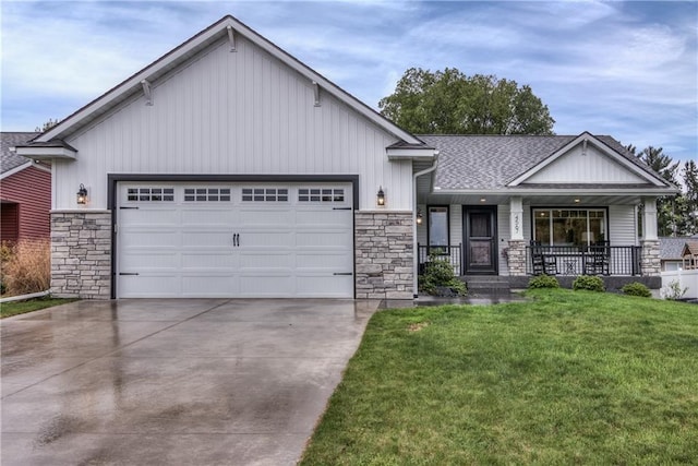 4567 Springfield Dr, Eau Claire, WI 54701 - view of front facade with stone siding, driveway, a porch, and a garage