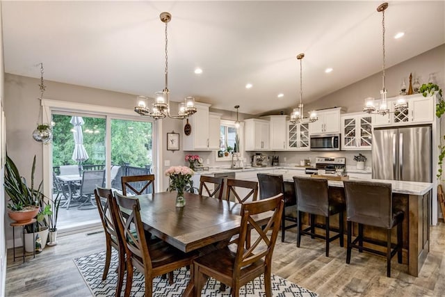 4567 Springfield Dr, Eau Claire, WI 54701 - dining room with a chandelier, light wood finished floors, recessed lighting, and vaulted ceiling