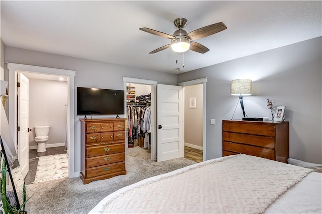 4567 Springfield Dr, Eau Claire, WI 54701 - bedroom featuring a spacious closet, a closet, baseboards, ensuite bath, and ceiling fan
