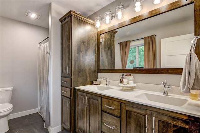 4567 Springfield Dr, Eau Claire, WI 54701 - full bathroom featuring toilet, double vanity, baseboards, and marble finish flooring