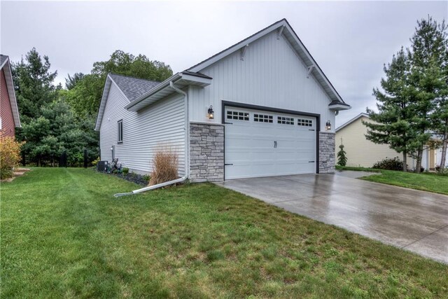 4567 Springfield Dr, Eau Claire, WI 54701 - view of front of home featuring driveway, a garage, board and batten siding, a front yard, and stone siding