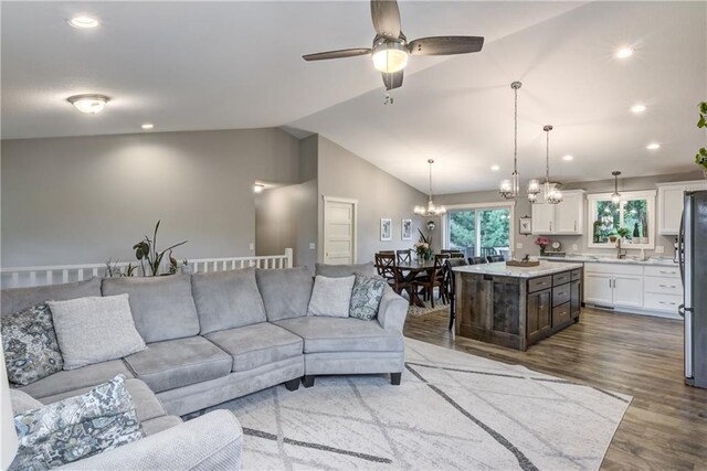 4567 Springfield Dr, Eau Claire, WI 54701 - living area with vaulted ceiling, a chandelier, ceiling fan, wood finished floors, and recessed lighting