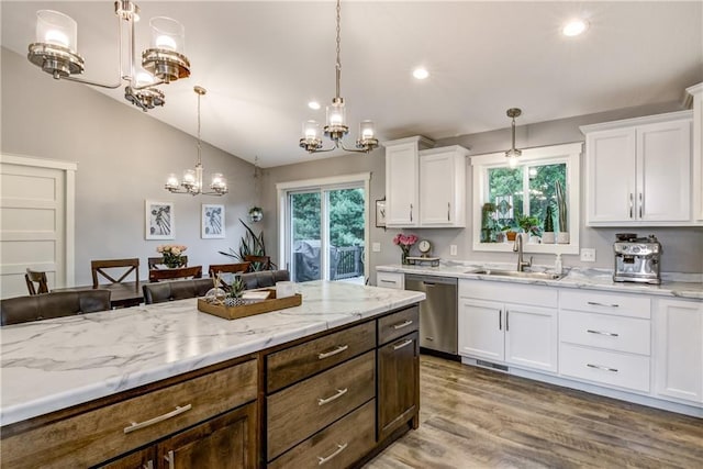 4567 Springfield Dr, Eau Claire, WI 54701 - kitchen featuring stainless steel dishwasher, a sink, white cabinetry, a chandelier, and pendant lighting