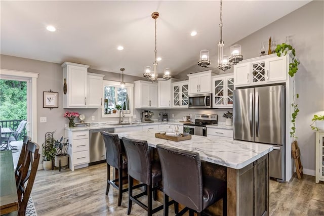 4567 Springfield Dr, Eau Claire, WI 54701 - kitchen with appliances with stainless steel finishes, a sink, a chandelier, healthy amount of natural light, and vaulted ceiling