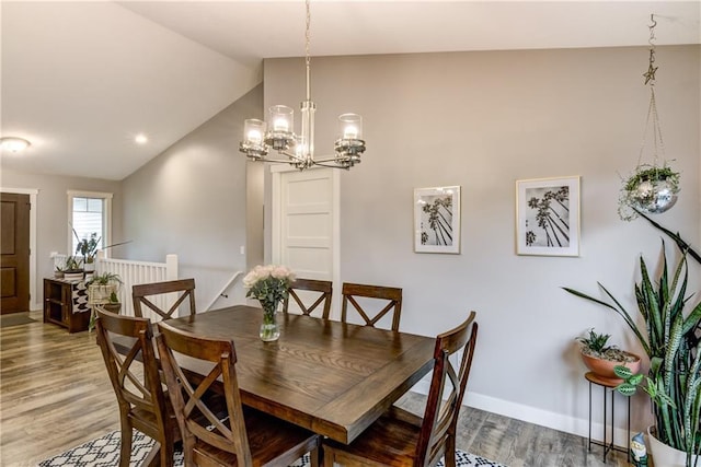 4567 Springfield Dr, Eau Claire, WI 54701 - dining area with lofted ceiling, a chandelier, light wood-type flooring, and baseboards