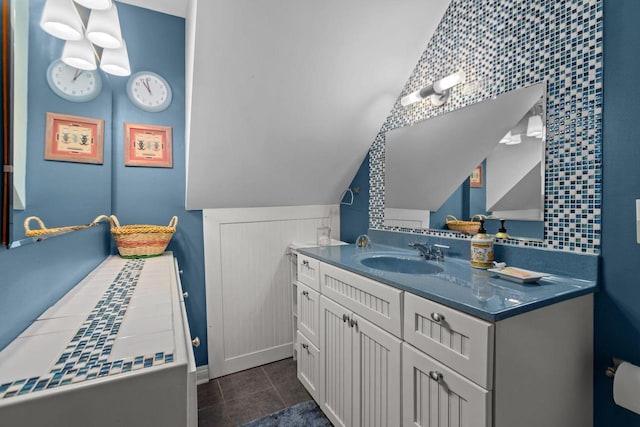 N3510 Lotus Dr, Montello, WI 53949 - bathroom featuring vanity, lofted ceiling, tile patterned flooring, and baseboards
